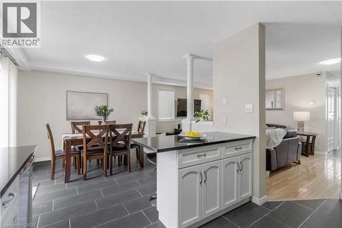 Kitchen with white cabinetry, open floor plan, stainless steel dishwasher. - 440 Langlaw Drive, Cambridge, ON - Indoor