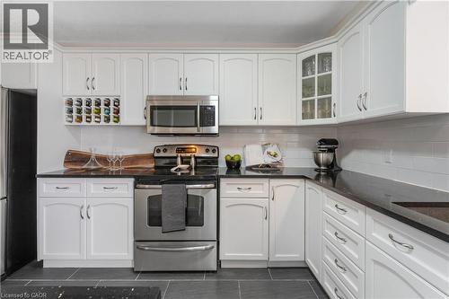 Kitchen with stainless steel appliances, white cabinets, quartz countertops,backsplash. - 440 Langlaw Drive, Cambridge, ON - Indoor Photo Showing Kitchen