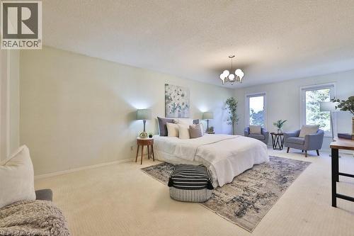 Bedroom with a chandelier, carpet floors, and a textured ceiling - 700 Fieldstone Road, Mississauga, ON - Indoor Photo Showing Bedroom