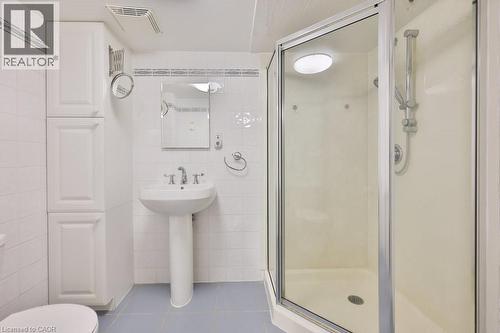 Full bathroom featuring tile walls, light tile patterned floors, and a shower stall - 700 Fieldstone Road, Mississauga, ON - Indoor Photo Showing Bathroom