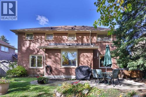 Rear view of property with a patio area, brick siding, and outdoor dining space - 700 Fieldstone Road, Mississauga, ON - Outdoor