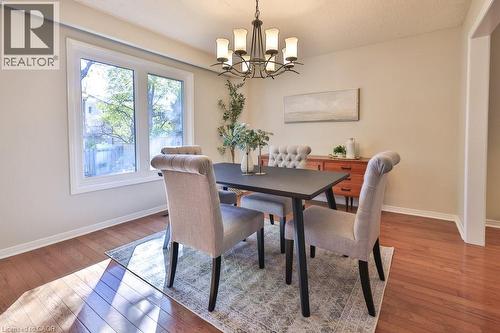 Dining area featuring light wood finished floors and a chandelier - 700 Fieldstone Road, Mississauga, ON - Indoor Photo Showing Dining Room