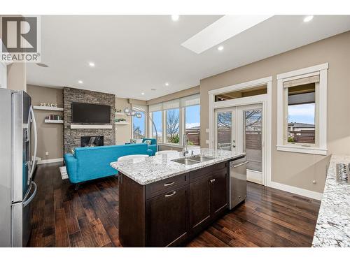 1768 Split Rail Place, Kelowna, BC - Indoor Photo Showing Kitchen With Fireplace With Double Sink