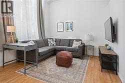 Living area with light wood finished floors and baseboards - 
