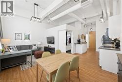 Dining space featuring a high ceiling and light wood-style floors - 