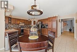 Dining room with light tile patterned floors and recessed lighting - 