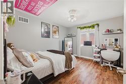 Bedroom with hardwood / wood-style flooring and a ceiling fan - 