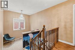 Hallway featuring an upstairs landing and baseboards - 