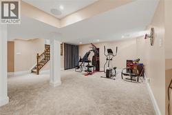 Exercise area with light colored carpet and recessed lighting - 