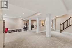 Exercise room with carpet flooring and recessed lighting - 