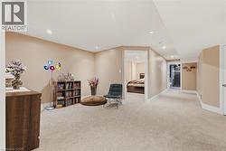 Sitting room with light colored carpet and recessed lighting - 