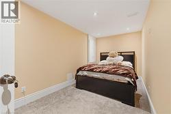 Carpeted bedroom featuring baseboards and recessed lighting - 