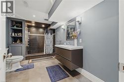 Full bathroom with vanity, a tile shower, and recessed lighting - 