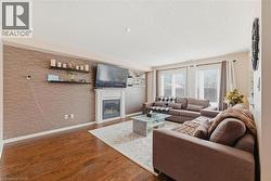 Living area with dark wood finished floors, a glass covered fireplace, and a textured ceiling - 