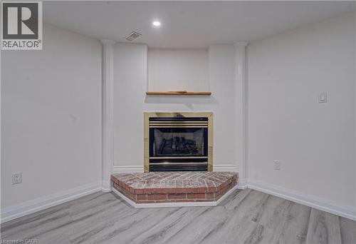 living room with gas fireplace - 383 Rexford Drive Unit# 2, Hamilton, ON - Indoor With Fireplace