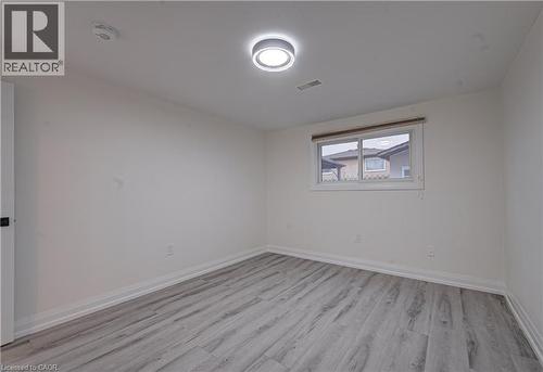 Unfurnished room featuring light wood-type flooring and baseboards - 383 Rexford Drive Unit# 2, Hamilton, ON - Indoor Photo Showing Other Room