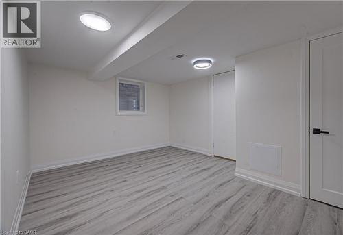 Unfurnished room featuring light wood finished floors and baseboards - 383 Rexford Drive Unit# 2, Hamilton, ON - Indoor Photo Showing Other Room