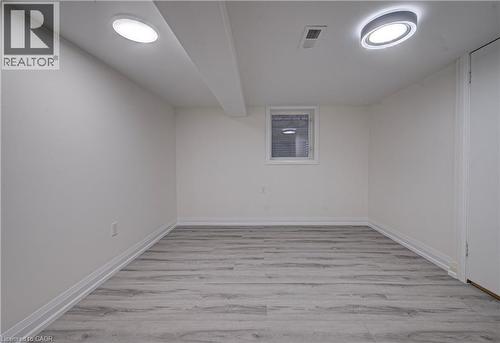 Empty room featuring light wood finished floors - 383 Rexford Drive Unit# 2, Hamilton, ON - Indoor Photo Showing Other Room