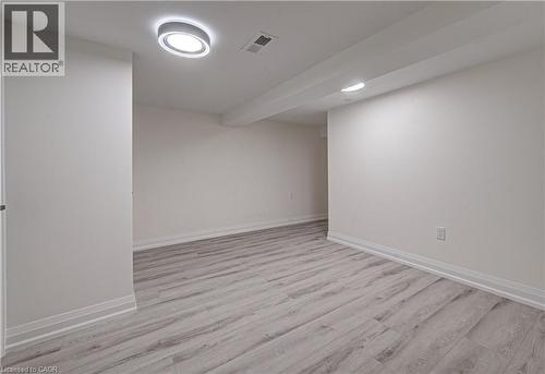 Primary bedroom 2 in lower level with light wood-type flooring and baseboards - 383 Rexford Drive Unit# 2, Hamilton, ON - Indoor