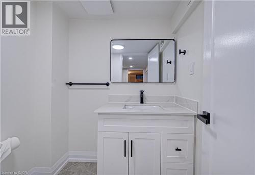 Half bathroom featuring vanity and baseboards - 383 Rexford Drive Unit# 2, Hamilton, ON - Indoor Photo Showing Bathroom