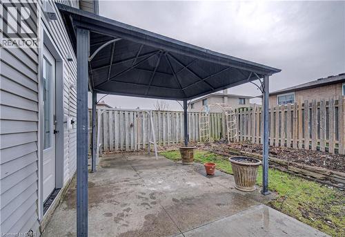 Fenced backyard featuring a patio area and a gazebo - 383 Rexford Drive Unit# 2, Hamilton, ON - Outdoor