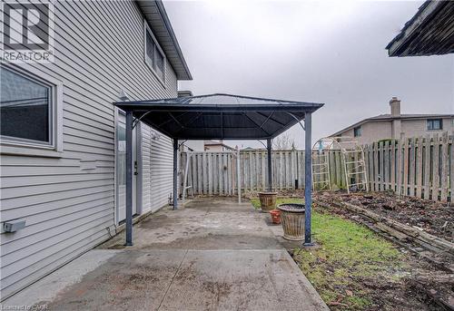 Fenced backyard featuring a patio area and a gazebo - 383 Rexford Drive Unit# 2, Hamilton, ON - Outdoor With Exterior