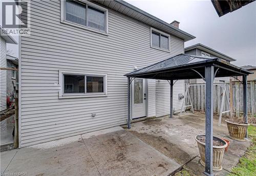 Rear view of property featuring a gazebo, a patio, and a chimney - 383 Rexford Drive Unit# 2, Hamilton, ON - Outdoor With Exterior