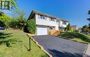 Split foyer home with brick siding, asphalt driveway, a front yard, and an attached garage - 90 Culpepper Drive, Waterloo, ON  - Outdoor 