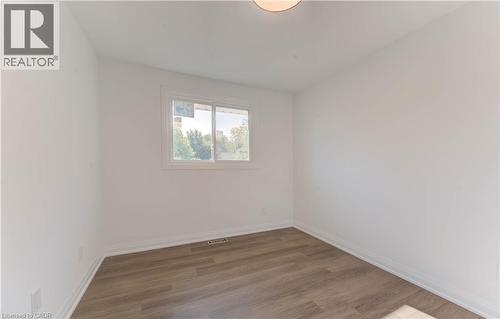 Unfurnished room featuring wood finished floors - 90 Culpepper Drive, Waterloo, ON - Indoor Photo Showing Other Room