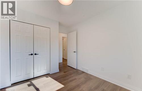 Unfurnished bedroom with wood finished floors and a closet - 90 Culpepper Drive, Waterloo, ON - Indoor Photo Showing Other Room