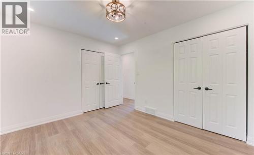 Unfurnished bedroom featuring light wood finished floors, two closets, and recessed lighting - 90 Culpepper Drive, Waterloo, ON - Indoor Photo Showing Other Room