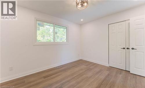 Unfurnished bedroom with light wood finished floors, a closet, and recessed lighting - 90 Culpepper Drive, Waterloo, ON - Indoor Photo Showing Other Room