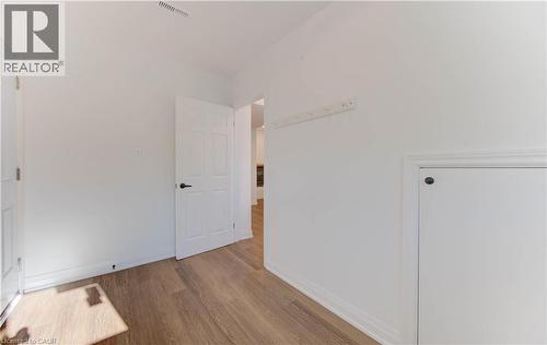 Unfurnished bedroom featuring wood finished floors and baseboards - 90 Culpepper Drive, Waterloo, ON - Indoor Photo Showing Other Room