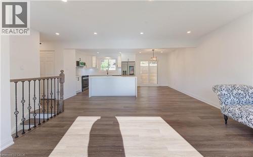 Kitchen with white cabinetry, open floor plan, recessed lighting, stainless steel appliances, and a center island - 90 Culpepper Drive, Waterloo, ON - Indoor