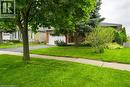 Obstructed view of property featuring an attached garage, a front lawn, driveway, and brick siding - 47 Claycroft Crescent Unit# Upper, Kitchener, ON  - Outdoor 
