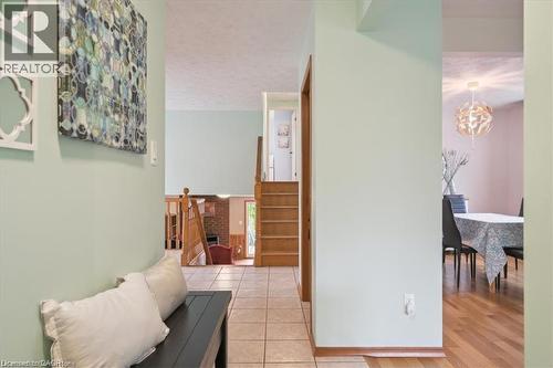 Hall with suspended lighting, light tile patterned floors, and a textured ceiling - 47 Claycroft Crescent Unit# Upper, Kitchener, ON - Indoor Photo Showing Other Room