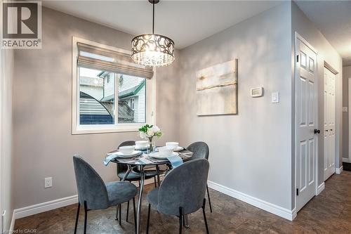 Dining room with stone finish floors and a chandelier - 236 Dartmoor Crescent, Waterloo, ON - Indoor Photo Showing Dining Room