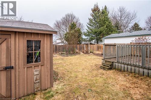 Fenced backyard featuring a wooden deck and a storage shed - 236 Dartmoor Crescent, Waterloo, ON - Outdoor