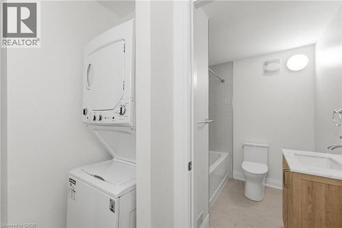Bathroom with vanity, stacked washer / drying machine, and tub / shower combination - 187 Oak Avenue Unit# Lower, Hamilton, ON - Indoor