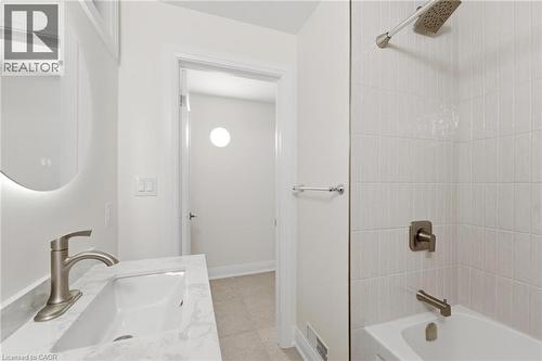Full bath with vanity, bathing tub / shower combination, and light tile patterned flooring - 187 Oak Avenue Unit# Lower, Hamilton, ON - Indoor Photo Showing Bathroom