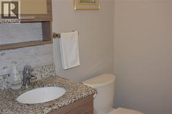 Bathroom with vanity and backsplash - 
