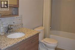 Full bath featuring vanity and shower / tub combo - 