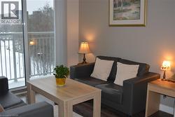 Living area with dark wood-type flooring - 
