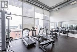 Gym featuring a city view, a high ceiling, and expansive windows - 