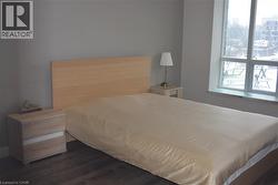Bedroom with dark wood-style flooring - 