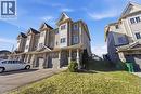 View of front facade with driveway, a front lawn, an attached garage, and stone siding - 208 Templewood Drive, Kitchener, ON  - Outdoor With Facade 