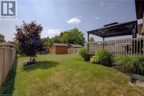 Fenced backyard with a shed and a trampoline - 128 Schmidt Drive, Arthur, ON - Outdoor