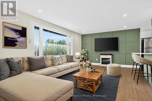 Digitally Staged - 556 Champlain Road, Tiny, ON - Indoor Photo Showing Living Room With Fireplace