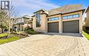 View of front of home featuring driveway, stone siding, a shingled roof, and an attached garage - 24 Jacob Gingrich Drive, Kitchener, ON  - Outdoor With Facade 