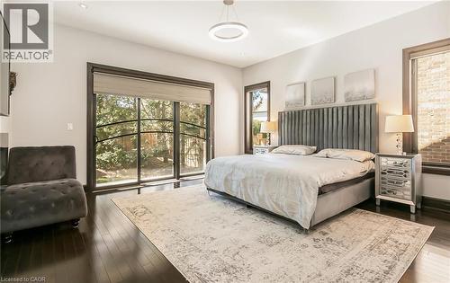 Bedroom featuring multiple windows, access to exterior, and dark wood-type flooring - 24 Jacob Gingrich Drive, Kitchener, ON - Indoor Photo Showing Bedroom